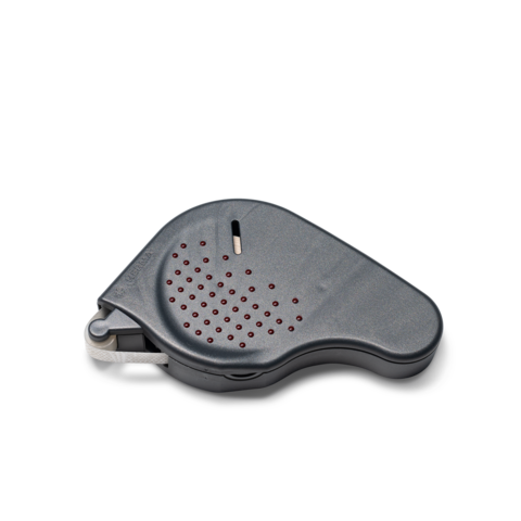 Ein graues, ergonomisch geformtes Gerät mit roten Punkten, vermutlich ein elektronischer Signalgeber oder Alarm.