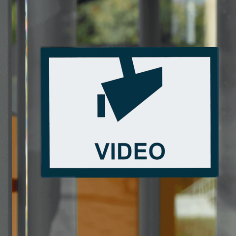 Schild mit der Aufschrift "VIDEO" und einem Symbol einer Kamera, das auf Videoüberwachung hinweist.